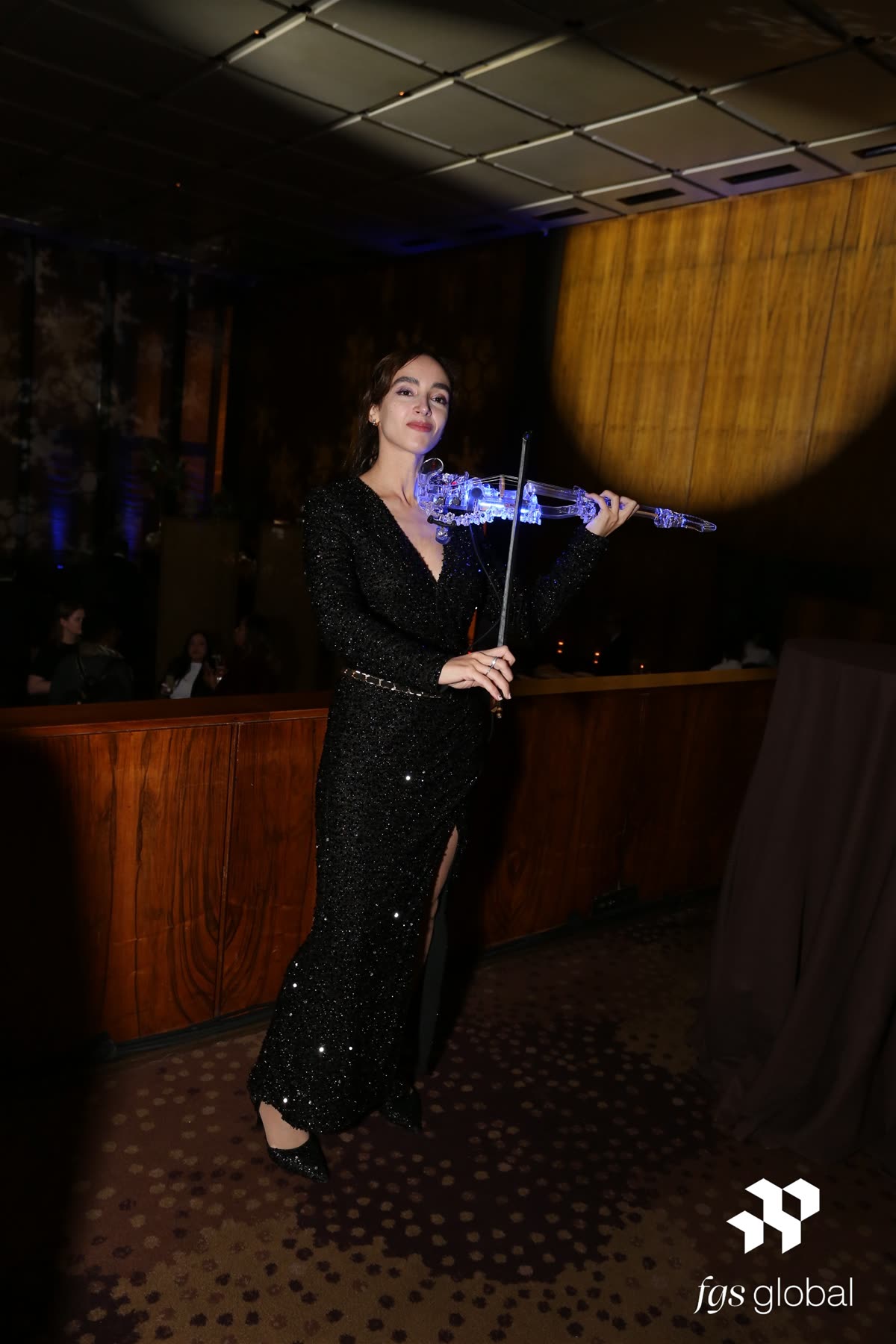 Sadie with the transparent violin in a dim evening venue