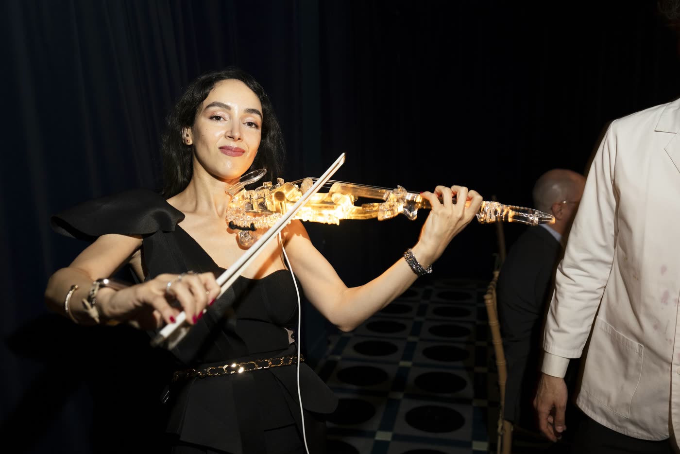 Close-up of Sadie smiling while playing the transparent violin